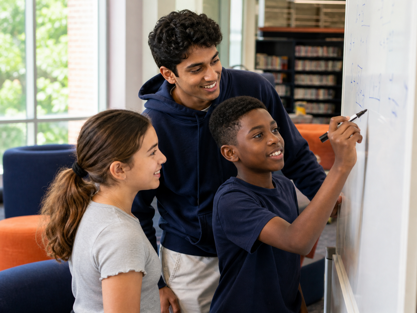 Teen mentor helping younger students